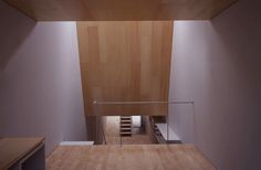 an empty room with wooden floors and stairs