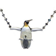 a necklace with a penguin on it and beads hanging from the back of its neck