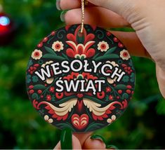 a person holding up a christmas ornament with the words wesollych swat on it