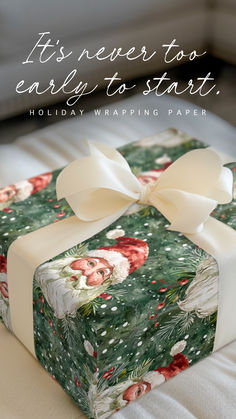 a present wrapped in wrapping paper with a white bow on it and the words, it's never to early to start holiday wrapping paper