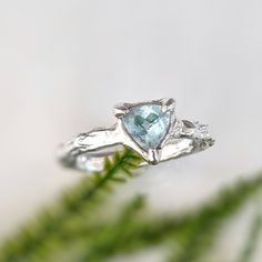 Rediscover love with our unique Aquamarine ring. Handcrafted in wax and Solid Silver, this captivating blue crystal ring boasts an organic textured band, ensuring its one-of-a-kind charm. Adorned with a mesmerizing trilliant shape Aquamarine, reflecting March's birthstone, this delicate ring signifies timeless love and individuality.T H E ∙ S M A L L ∙ D E T A I L S• Trilliant shape Aquamarine (6mm)• Sterling Silver molten bandM A T E R I A L ∙ O P T I O N S• Sterling Silver• Solid 14k GoldYou w Blue Crystal Ring, Timeless Love, Aquamarine Ring, Aquamarine Rings, Crystal Ring, Delicate Rings, March Birth Stone, Crystal Rings, Blue Crystals