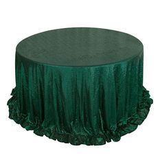 a green table cloth with ruffles on the top and bottom, in front of a white background