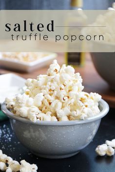 salted truffle popcorn in a bowl on a table with other food items