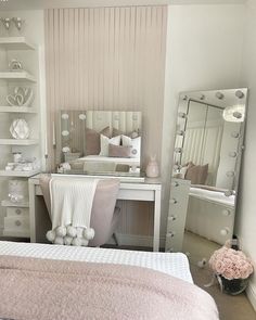 a bedroom with a bed, dresser and mirror in it's corner is shown