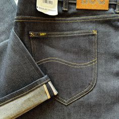 Elevate Your Denim Game With These Lee Heritage Raw Selvedge Denim Jeans. These Jeans Feature A Mid-Rise Fit With A Straight Leg Style, And Are Made From A Comfortable Cotton Blend Fabric With A Raw Wash Finish. The 5-Pocket Design Includes A Button And Zipper Closure, With The Lee Logo Accenting The Back Pocket. Casual Dark Wash Bottoms With Double-needle Stitching, Casual Denim Blue Bottoms With Double-needle Stitching, Casual Indigo Bottoms With Double-needle Stitching, High Rise Denim Blue Selvedge Bottoms, Blue Denim Bottoms With Double-needle Stitching, Back Pocket, Selvedge Denim Men, Lee Jeans Mens, Slim Fit Mens Jeans