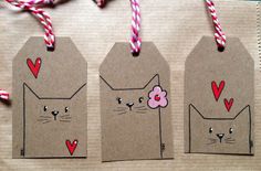 three tags with cats and hearts on them