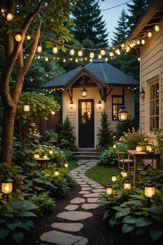 a pathway that has lights strung over it and some plants on the side of it