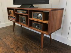 an entertainment center with two stereos on it