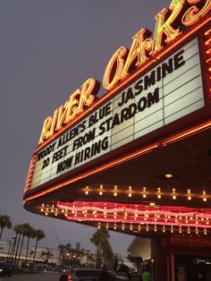 the marquee for river oak theatre is lit up at night with bright lights