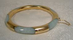 A 14k and jadeite bangle bracelet from the 1930s. This exceptional vintage round yellow gold and genuine natural jadeite bracelet has hand engraved gold encasing or wrapping around the light green mottled jade.  Unlike many examples this one has continuous gold around the interior and six wraps around the jade hoop.  It measures 2-3/8" across the interior wall (inside of bangle measurement) and is 5/16" wide or thick. It has a typical clasp with a heart shaped button.  It is stamped 585 and 14K Round Jade Collectible Jewelry, Collectible Round Jade Jewelry, Vintage Jade Round Bracelets, Vintage Round Jade Bracelets, Vintage Jade Bracelets, Vintage Jade Bangle, Antique Accessories, Art Deco Jewelry Vintage, Bracelets Vintage