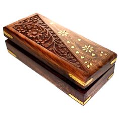 an intricately carved wooden box is shown on a white background with gold trimmings