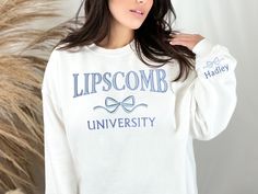 Customize your cozy sweatshirt with your college name, mascot, sport, school name, or more!  Choose a crew neck or hoodie in your favorite color. Initials or word (capital letters) will be embroidered in the cute and preppy arched font, with a cute and trendy coquette bow embroidered below. You may also customize with text of your choice below the bow.  Also includes a name or text of your choice along with a bow embroidered on the sleeve near the cuff. Our high quality embroidery ensures that t White School Spirit Sweatshirt For Campus, White University Logo Sweatshirt With Crew Neck, White University Logo Crew Neck Sweatshirt, White University Logo Sweatshirt, Crew Neck, School Spirit Crew Neck Sweatshirt For College Events, School Spirit Sweatshirt For College Events, University Logo Sweatshirt For School Spirit, Varsity Long Sleeve Sweatshirt For College Events, School Spirit Long Sleeve Sweatshirt For College Events