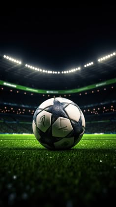 a soccer ball sitting on top of a green field in front of an empty stadium