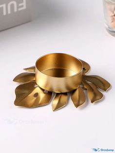 a gold ring sitting on top of a white table