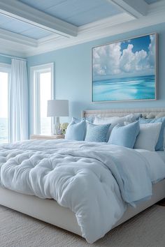 a bedroom with blue walls and white bedding