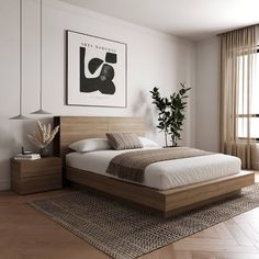 a bedroom with a bed, nightstands and pictures on the wall