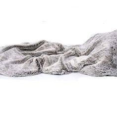 a blanket that is laying on top of a white surface with no one around it