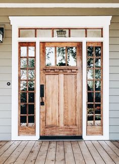 the front door to a house with two windows and wood flooring on top of it