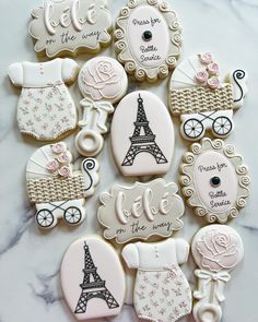 some cookies that are decorated to look like the eiffel tower and baby carriages