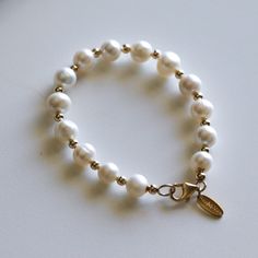 "The Real Pearl Bracelet is a beautiful bead bracelet that brings a touch of elegance and charm to your wrist. Made from genuine Gemstone beads,  This  Freshwater Pearl Bracelet showcases the beauty of natural Stone crystals, and when paired with a beautiful gold Link Chain, it creates a beautiful and harmonious look. This Delicate Bracelet is made with genuine Stone. Real Pearl is a natural gemstone that comes from the earth and is of the highest quality and authenticity. Recall your fondest beach memories with the luxurious Bora Bora Pearl bracelet. This bracelet features 10mm genuine cultured freshwater pearls paired with 14k gold accents and is made to order. Please allow 1 to 5 business days for fulfillment. 🌟 Product Details 🌟  Sizes: 7\", 8\", 8.25\", 8.5\", 9\" Metal options: 14k Elegant Charm Bracelet With Pearl And Round Beads, Classic Everyday Beaded Bracelets With Pearl Charm, Elegant Silver Name Bracelet With Round Beads, Elegant Beaded Rosary Bracelet, Elegant Everyday Pearl Stretch Bracelet, Elegant Stretch Bracelet With Pearl Charm And Round Beads, Elegant Pearl Beaded Charm Bracelet, Elegant Adjustable Beaded Charm Bracelet, Elegant Pearl Rosary Bracelet With Round Beads