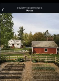 a red barn sitting next to a lush green field