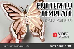 a hand holding a paper butterfly with the text, diy craft tutors svg / dxf