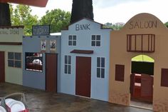 several model buildings are displayed in front of a tree