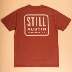 Still's classic stacked logo on our 'Brick Red' Feather Grass tee. Holiday Chaos, Red Feather, Brick Red, Buy One Get One, Get Directions, Whiskey, Tee Shirt, Screen Printing, Austin