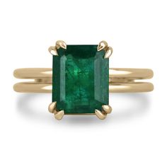 This 3.28 carat natural Zambian emerald is a true statement piece. The deep, dark green color of the stone is absolutely breathtaking and is sure to draw attention. The emerald is set in a simple four-prong setting with double claw prongs, which ensures that the stone is securely held in place. The split shank of the ring is made in 18k yellow gold, which complements the rich green of the emerald perfectly. The split shank adds a modern touch to the classic four-prong setting, making the ring both timeless and contemporary. Setting Style: Prong - Solitaire Setting Material: 18K Yellow Gold Setting Weight: 7.2 Grams Main Stone: Emerald Shape: Emerald Cut  Weight: 3.28-Carats Clarity: Semi-Transparent Color: Deep Dark Green Luster: Good Treatments: Natural, Oiling Origin: Zambia Estimated Re Vintage Emerald Gold Ring, Simple Ring With Stone, East West Engagement Ring Emerald, Emerald Stone Rings, Colombian Emerald Ring, Emerald Set, Emerald Ring Gold, Right Hand Ring, Dark Green Color