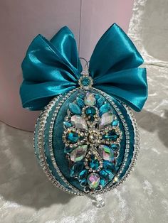 a blue ornament with a large bow on it