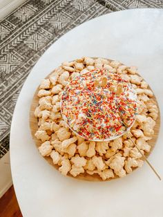 a white plate topped with lots of sprinkles on top of a table