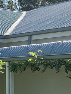 a bird sitting on the roof of a house