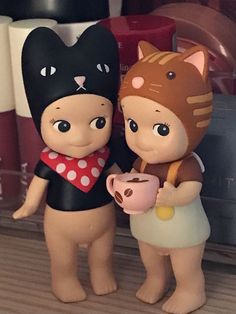 two plastic figurines are standing next to each other