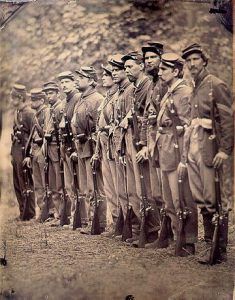 an old photo of men in uniforms standing together