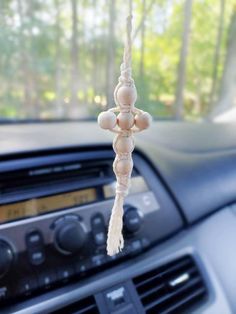 a car dashboard with an air freshener hanging from the dash