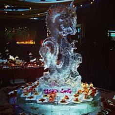 an ice sculpture in the shape of a horse with flowers on it's head