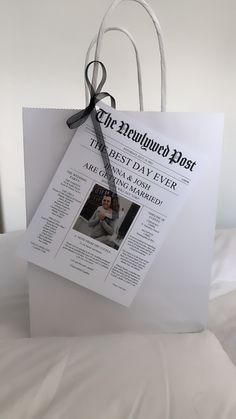 a paper bag with an ad for the new york post hanging from it's handle