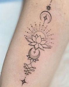 a black and white photo of a sunflower tattoo on the left arm with stars