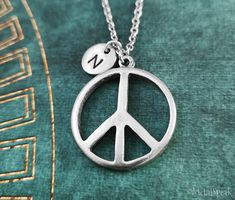 Adjustable Sterling Silver Peace Sign Jewelry, Personalized Symbolic Initial Pendant Charm Necklace, Inspirational Adjustable Nickel-free Charm Necklaces, Adjustable Symbolic Stamped Necklace, Adjustable Inspirational Nickel-free Charm Necklace, Symbolic Silver Jewelry With Peace Sign, Silver Peace Sign Jewelry Gift, Symbolic Round Peace Sign Jewelry, Symbolic Personalized Charm Necklaces