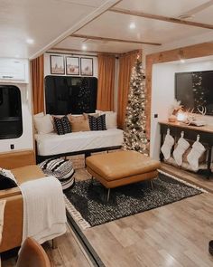 a living room filled with furniture and a christmas tree