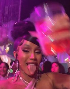 a woman sticking out her tongue at a party