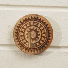 a wooden door knob with a decorative design on it