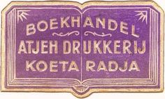 a purple sign that says boekhandel athe drukkeru koeta radia