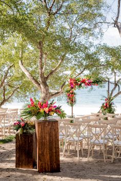 an outdoor ceremony set up with chairs and flowers