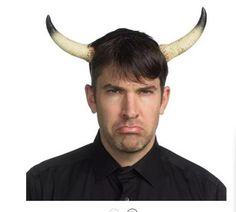 a man with horns on his head is looking at the camera