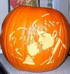 a carved pumpkin with the face of a man and woman on it