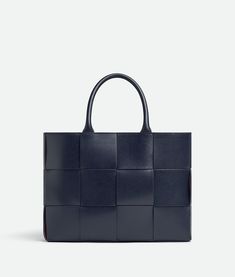 "Find BOTTEGA VENETA Small Arco Tote Bag With Strap on Editorialist. Small Intreccio leather tote bag with adjustable and removable strap. Single interior zipped flat pocket. Lining: Suede bonded Intreccio. Colour: Space/Barolo. Hardware: Silver finish. Height: 24 cm | 9.4\". Width: 32 cm | 12.6\". Depth: 8 cm | 3.1\". Handle drop: 12 cm | 4.7\". Strap drop: 45 cm | 17.7\". Calfskin." High-end Office Shoulder Bag With Leather Handles, High-end Shopping Shoulder Bag With Leather Handles, Designer Leather Box Bag For Shopping, High-end Leather Handles Tote Shoulder Bag, High-end Satchel With Leather Handles For Shopping, High-end Shoulder Box Bag With Leather Handles, High-end Box Bag With Leather Handles For Everyday Use, Designer Square Leather Bag, Luxury Square Bags With Leather Handles