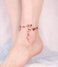 a close up of a person's foot with flowers on it