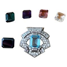 AN ART DECO DIAMOND DOUBLE CLIP BROOCH, BY OSTERTAG, 1930s, Of stylised shield outline, with pave-set brilliant cut Diamonds and Baguette Diamonds. The brooch features a square centre stone that is interchangebale. Blue Topaz 8.45 ct, white Crystal Quartz 7.35 ct, Amethyst 6.95, Tourmaline 7.50 ct, Onyx 9.90 ct and pink Topaz 7.65 ct. Dimensions: 3.50 cm x 3.30 cm. Weight without centre gemstone: 13.25 grams. The brooch can also be worn with a 18 K white Gold multistand necklace, 25.40 grams. The necklace is not original from the brooch and period but makes it much more wearable. Length of necklace: 43 cm. Comes in original box! Ostertag was founded in the 1920’s by Swiss-born Arnold Ostertag, who opened his jewelry house in Place Vendôme in 1922, as well as in Cannes, Le Touquet and New Y Shield Outline, Gemstone Art, Baguette Diamonds, Diamond Brooch, Pink Topaz, French Art Deco, Art Deco Diamond, White Crystal, Baguette Diamond