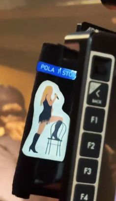 a close up of a cell phone with a sticker on it